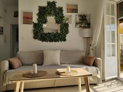 a living room with a couch and two candles on a table at Apartamento Cristina centro in Sanlúcar de Barrameda