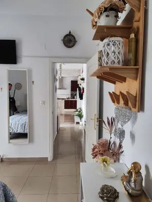 a room with a hallway with a bed and a mirror at Apartamento Cristina centro in Sanlúcar de Barrameda