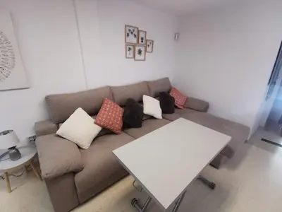 a living room with a couch and a table at La Gema de La Caleta in Cádiz
