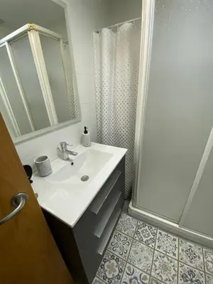 a bathroom with a sink and a shower at La Gema de La Caleta in Cádiz