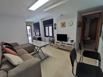 a living room with a couch and a table at La Gema de La Caleta in Cádiz