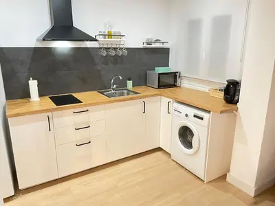 a kitchen with a sink and a washing machine at El pisito Sanlúcar in Sanlúcar de Barrameda