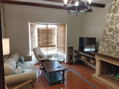 a living room with a couch and a fireplace at Casa El Veranito in Chiclana de la Frontera