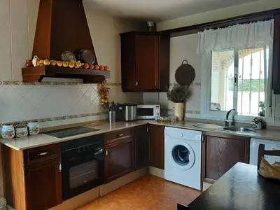 a kitchen with a washer and a sink and a dishwasher at Casa El Veranito in Chiclana de la Frontera