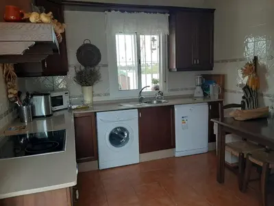 a kitchen with a washing machine and a dishwasher at Casa El Veranito in Chiclana de la Frontera