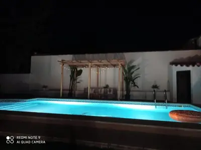 a large swimming pool in a building with at Casa El Veranito in Chiclana de la Frontera