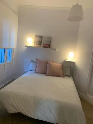 a bedroom with a bed with two pillows on it at Chipiona Acogedor LA in Chipiona