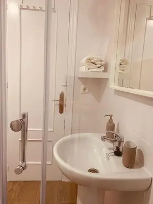 a white bathroom with a sink and a shower at Chipiona Acogedor LA in Chipiona