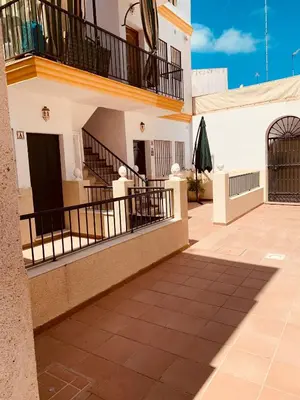 a building with two balconies and a patio at Chipiona Acogedor LA in Chipiona