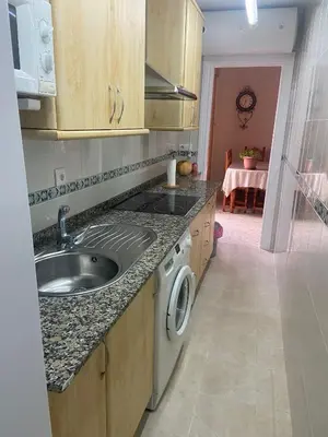a kitchen with a sink and a washing machine at MyChoice Blas Infante in Rota