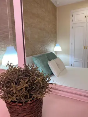 a bedroom with a bed and a mirror at MyChoice Blas Infante in Rota