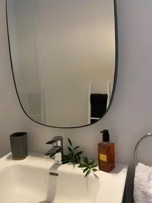 a bathroom with a sink with a large mirror at MEDINA BLUE - CASITAS CON ENCANTO in Medina Sidonia