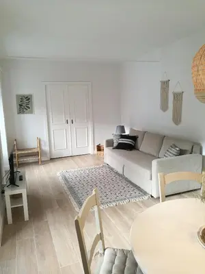 a white living room with a couch and a table at MEDINA BLUE - CASITAS CON ENCANTO in Medina Sidonia