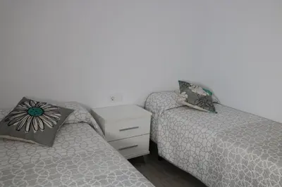 two beds sitting next to each other in a bedroom at Naveros Bajo in Los Naveros