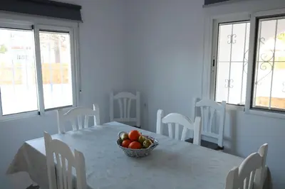 a dining room with a table with a bowl of fruit on it at Naveros Bajo in Los Naveros