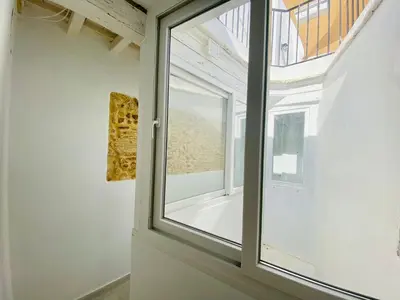 an open window in a room with a white wall at Luz, aire y mar Grupo AC Gestion in Cádiz