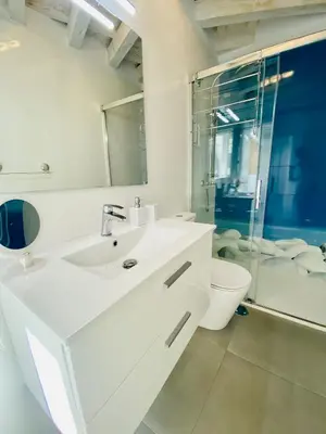 a white bathroom with a sink and a toilet at Luz, aire y mar Grupo AC Gestion in Cádiz