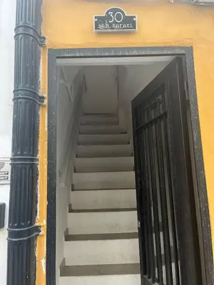 a stairway with a black door and stairs in a building at Luz, aire y mar Grupo AC Gestion in Cádiz
