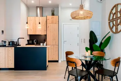a kitchen and dining room with a table and chairs at Genteel Home Sagasta in Cádiz