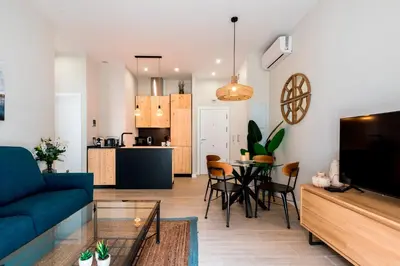 a living room with a blue couch and a table at Genteel Home Sagasta in Cádiz