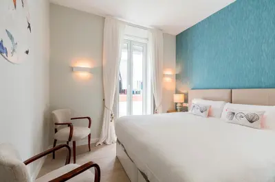a bedroom with a large white bed and a window at Genteel Home Sagasta in Cádiz