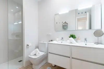 a white bathroom with a sink and a toilet at Genteel Home Sagasta in Cádiz