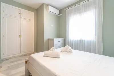 a bedroom with a bed with towels on it at Allo Apartments Plateros II Centro 2 Habitaciones in Jerez de la Frontera