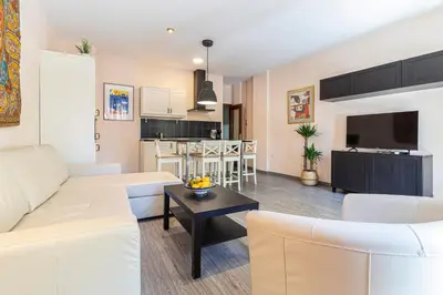 a living room with a couch and a table at Allo Apartments Plateros II Centro 2 Habitaciones in Jerez de la Frontera