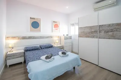 a bedroom with a bed and two towels on it at Apartamento Ooh La Lá Cádiz in Cádiz