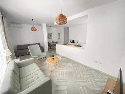 a living room with a couch and a table at Apartamento en calle Ancha, en pleno centro in Sanlúcar de Barrameda