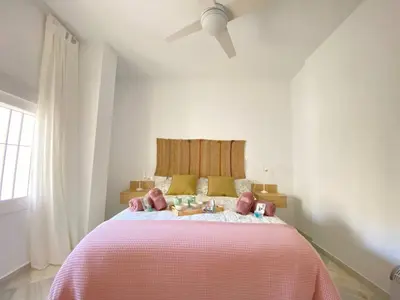 a bedroom with a pink bed with stuffed animals on it at Apartamento en calle Ancha, en pleno centro in Sanlúcar de Barrameda