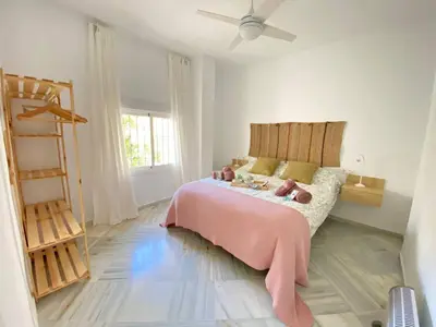 a bedroom with a pink bed with teddy bears on it at Apartamento en calle Ancha, en pleno centro in Sanlúcar de Barrameda