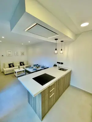 a kitchen with a sink and a living room at GATU PREMIUM Alma marinera, Preferente mayores de 21 años y familias in Cádiz