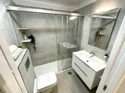 a bathroom with a shower and a sink and a toilet at GATU PREMIUM Alma marinera, Preferente mayores de 21 años y familias in Cádiz