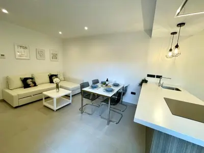 a living room with a couch and a table at GATU PREMIUM Alma marinera, Preferente mayores de 21 años y familias in Cádiz