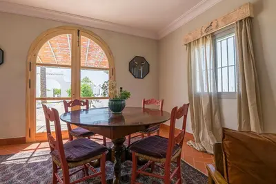 a dining room with a table and chairs and a window at Cortijo La Mina by LaJudería de Vejer - Luxury Villa in Conil de la Frontera