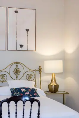 a bedroom with a bed and a table with a lamp at Cortijo La Mina by LaJudería de Vejer - Luxury Villa in Conil de la Frontera