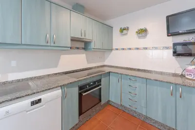 a kitchen with blue cabinets and a sink at Costa Ballena Unifamiliar in Costa Ballena