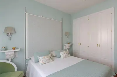 a bedroom with a white bed with two pillows on it at Costa Ballena Unifamiliar in Costa Ballena