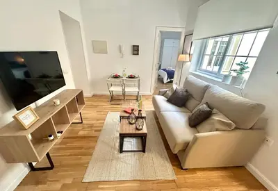 a living room with a couch and a table at GATU Ringo in El Puerto de Santa María