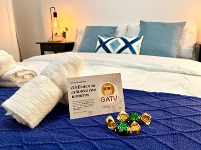 a bed with a sign on top of it at GATU Ringo in El Puerto de Santa María