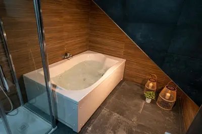 a bath tub in a bathroom with a shower at Apartamento Cabildo Spa 2 in Sanlúcar de Barrameda