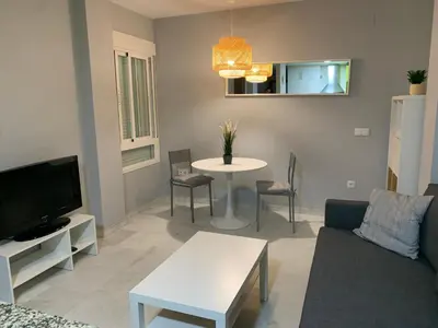 a living room with a couch and a table at Apartamento a 5 minutos de la playa de la caleta in Cádiz