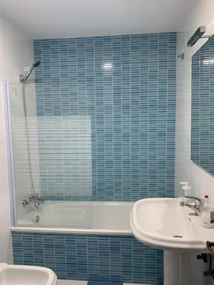 a bathroom with a tub and a toilet and a sink at Apartamento a 5 minutos de la playa de la caleta in Cádiz