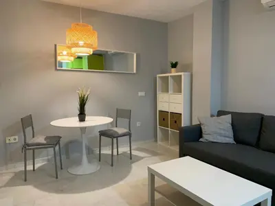 a living room with a couch and a table at Apartamento a 5 minutos de la playa de la caleta in Cádiz