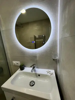 a bathroom with a white sink and a mirror at GATU Villa Soleá parking, piscina, pistas tenis, playa de Valdelagrana in El Puerto de Santa María