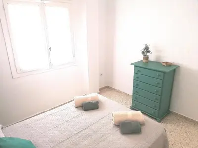 a bedroom with a green dresser and a blue cabinet at Apartamento Tres Carabelas, AC, Wifi, Parking in Sanlúcar de Barrameda