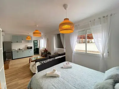 a living room with a bed and a couch at Apartamento Trascuesta, PLENO CENTRO in Sanlúcar de Barrameda