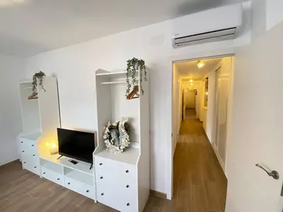 a living room with a tv and a dresser at Apartamento Trascuesta, PLENO CENTRO in Sanlúcar de Barrameda