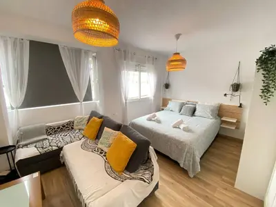 a living room with a bed and a couch at Apartamento Trascuesta, PLENO CENTRO in Sanlúcar de Barrameda